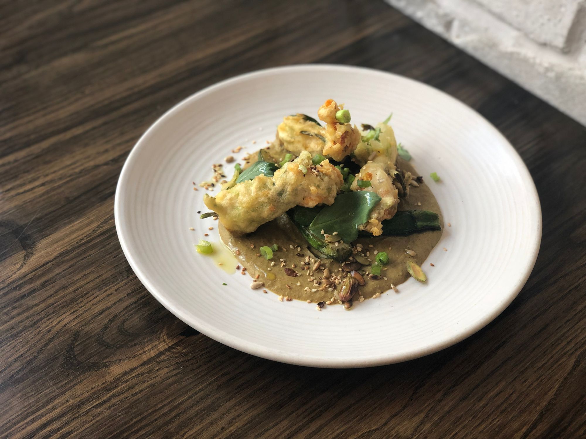 Picture of cheese stuffed squash blossoms with green pistacio mole